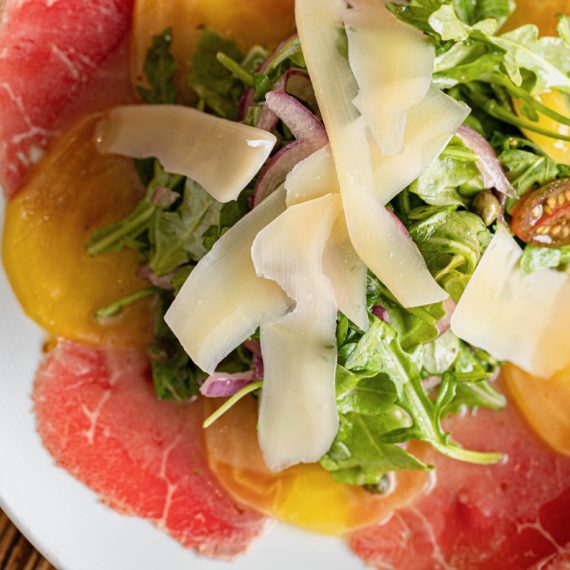 Beef carpaccio with arugula, golden beets, and shaved cheese