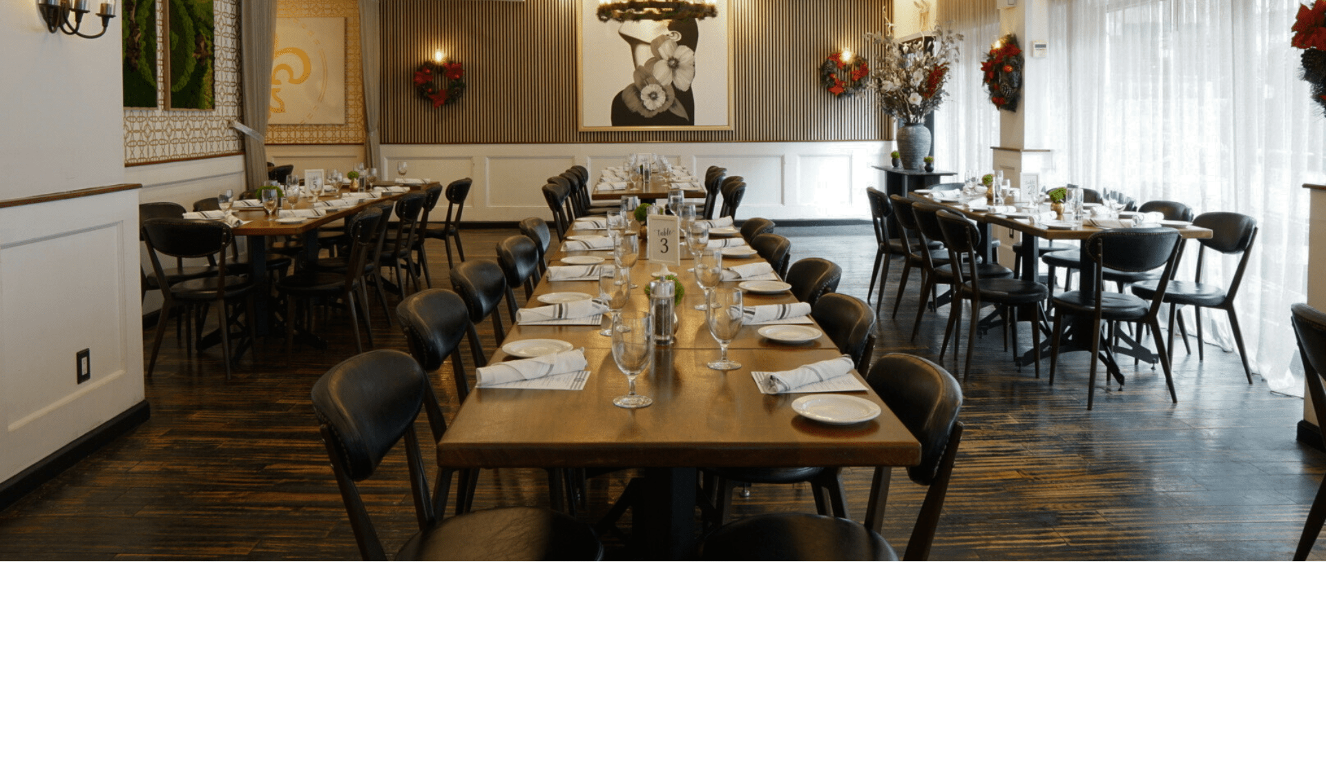 Festively decorated dining room with long tables set up for a private holiday party