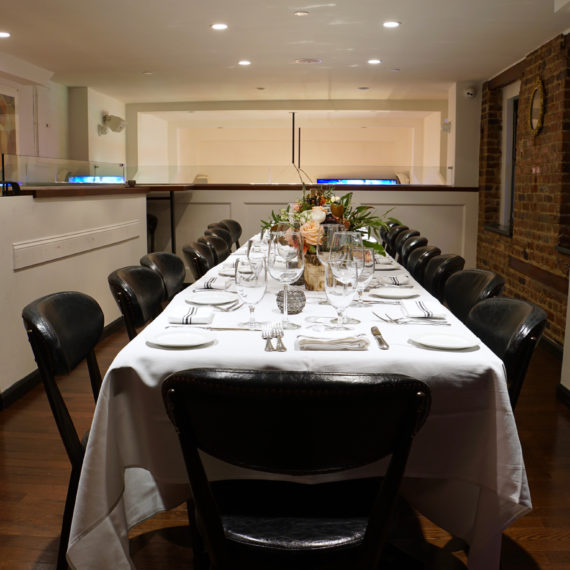 Elegant long table set for dinner in a private room