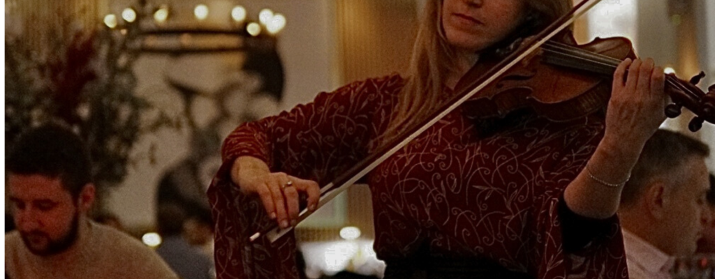 zoomed in shot of violinist playing in dining room
