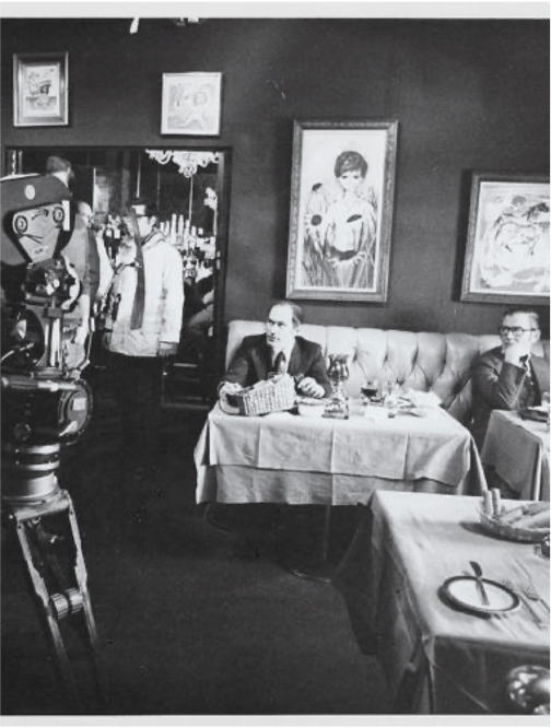 Black and white behind-the-scenes image of a restaurant scene being filmed for The French Connection (1971 Best Picture), inside the restaurant called Copain