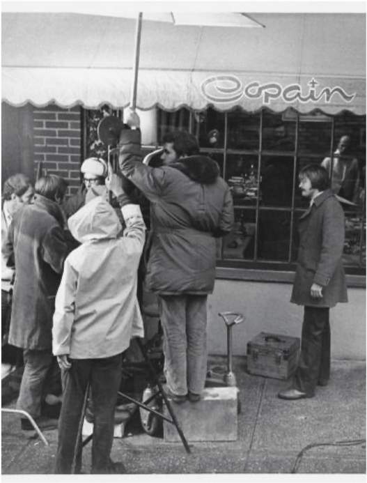 Black and white behind-the-scenes photo of the filming of The French Connection (1971 Best Picture) outside the restaurant Copain
