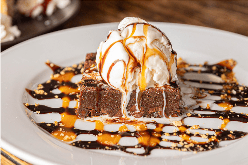 Brownie sundae with vanilla ice cream, chocolate and caramel drizzle