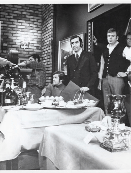 Black-and-white photo of film crew from the movie French Connection shooting a restaurant scene in the restaurant called Copain in 1972