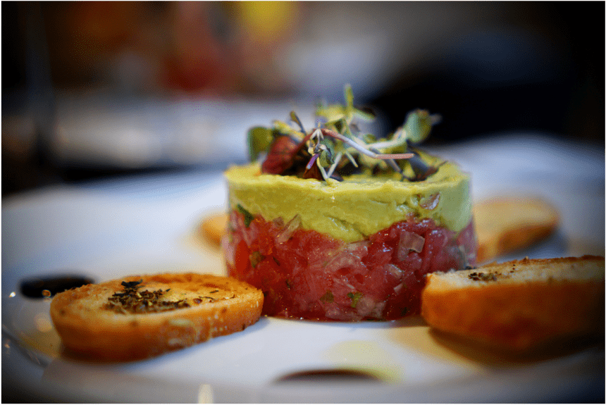 Tuna tartare with avocado mousse and microgreens, served with crostini