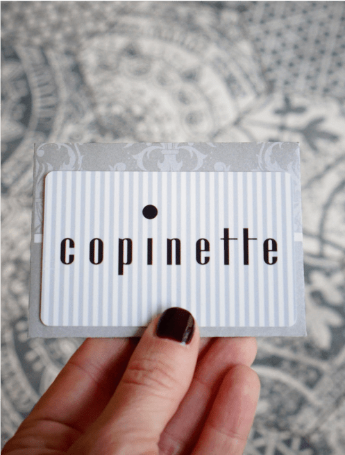 Hand holding a Copinette gift Card