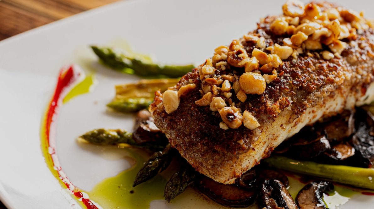 hazelnut-crusted halibut with asparagus, mushrooms, and sauce drizzle