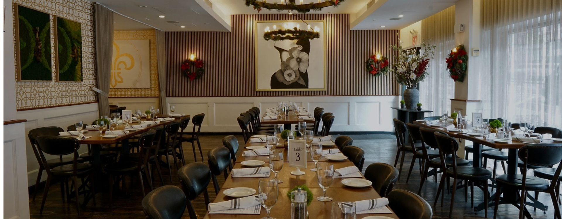 Festively decorated dining room with long tables set up for a private holiday party