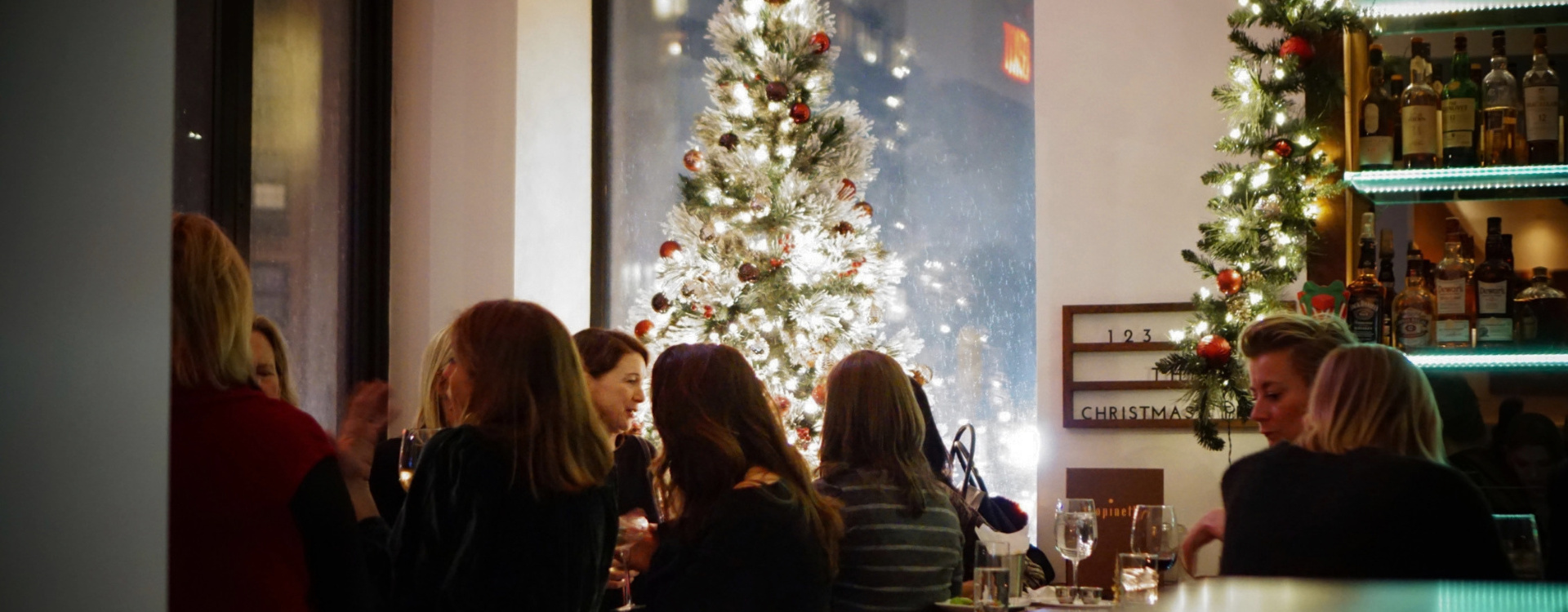 Gathering at bar light by Christmas tree